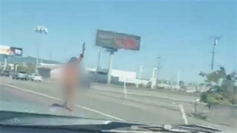 Naked female driver exits car on Bay Bridge approach and